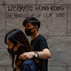 Protesters walk in front of graffiti during a rally in Chartered Garden on August 16, 2019 in Hong Kong